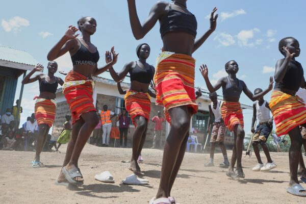Fusion between culture and modernity as children dance in Kenyan refugee camp