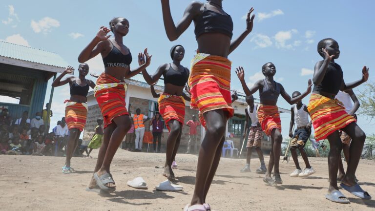 Fusion between culture and modernity as children dance in Kenyan refugee camp