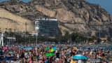 Tourists tackle geopolitical risks, currency moves and extreme heat