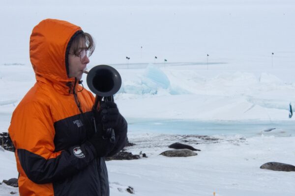 On the world’s coldest stage, a military musician plays with a plastic horn and double gloves