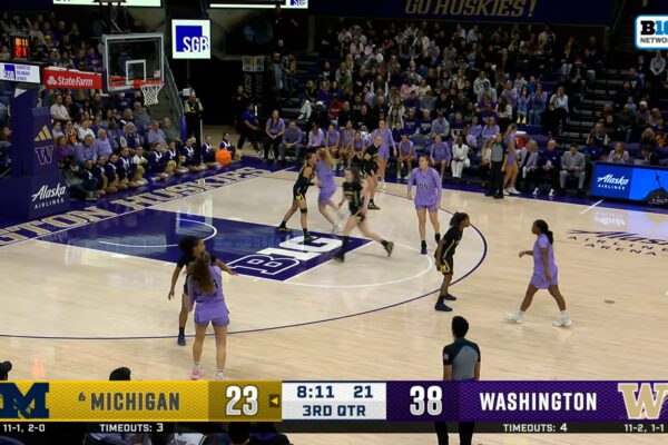 Washington's Elle Ladine connects with Avery Howell off tough skip pass against Michigan
