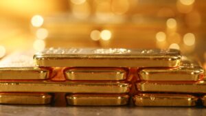 Gold slips to one-week low as safe-haven buying stalls, dollar strengthens