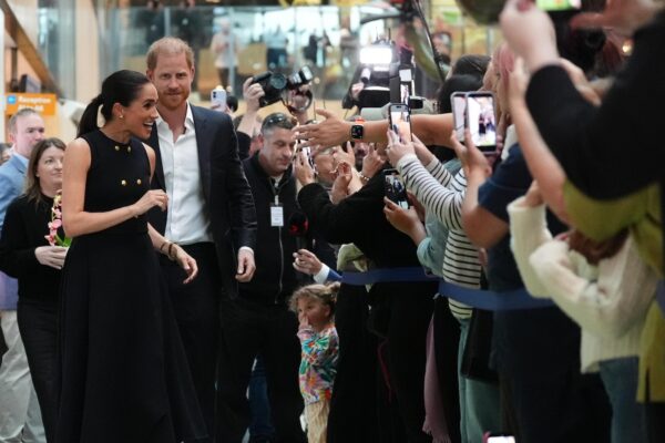 Prince Harry and Meghan arrive in Australia for a low-key, privately funded visit