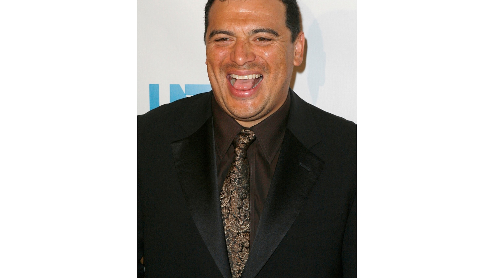 Comedian Carlos Mencia pleads not guilty to 12 felony charges of failure to pay taxes